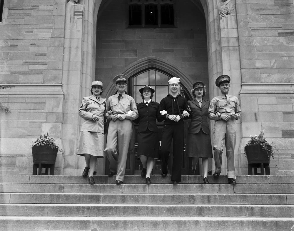  Black and white photograph showing three women and three men in various uniforms of the U.S. armed forces.