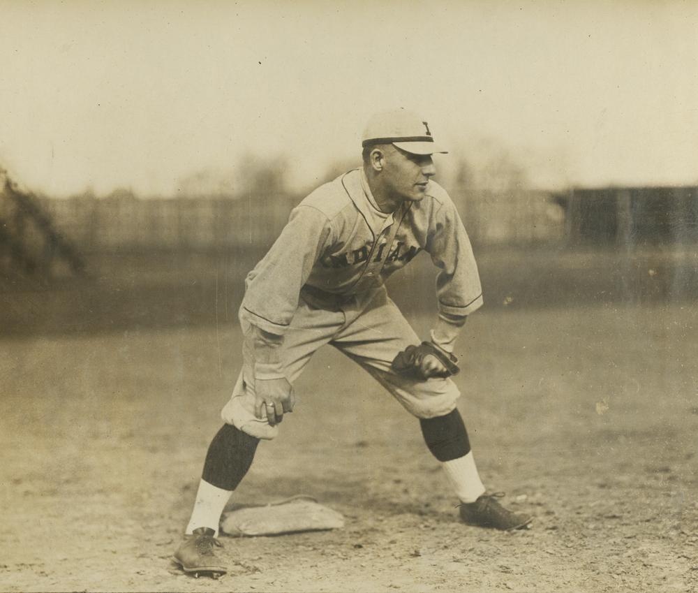  Black and white photograph of a baseball player in the field. 
