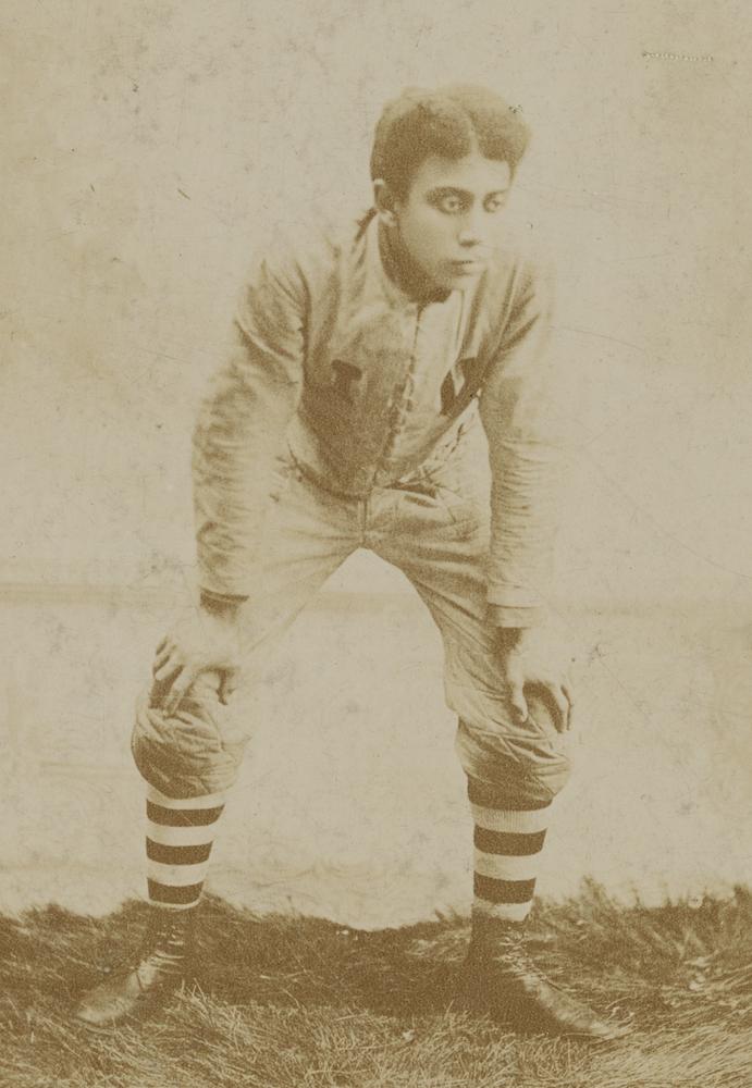 Sepiatone posed photo of Preston Eagleson in football uniform, 1893